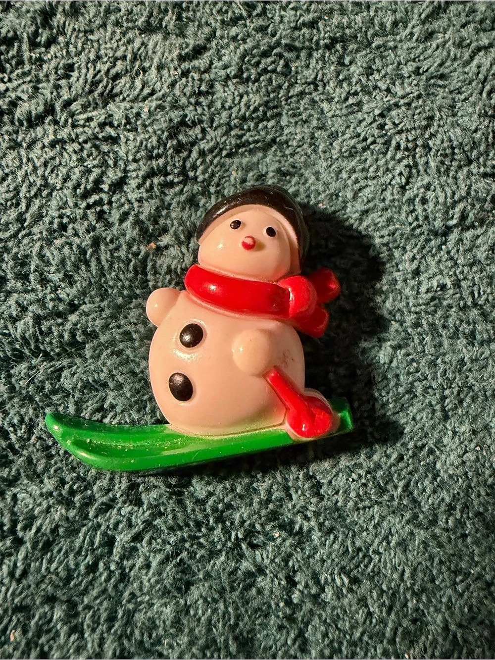 Snowman Figure on Green Sled